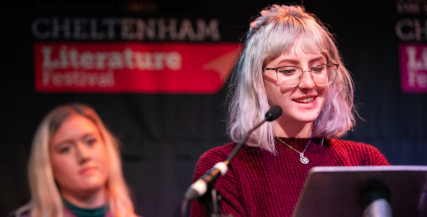 Young Writer reading on stage at Cheltenham Literature Festival Young Writer reading on stage at Cheltenham Literature Festival